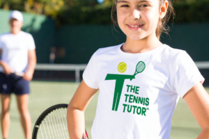 the tennis tutor logo on a white kids t-shirt on court angle limited